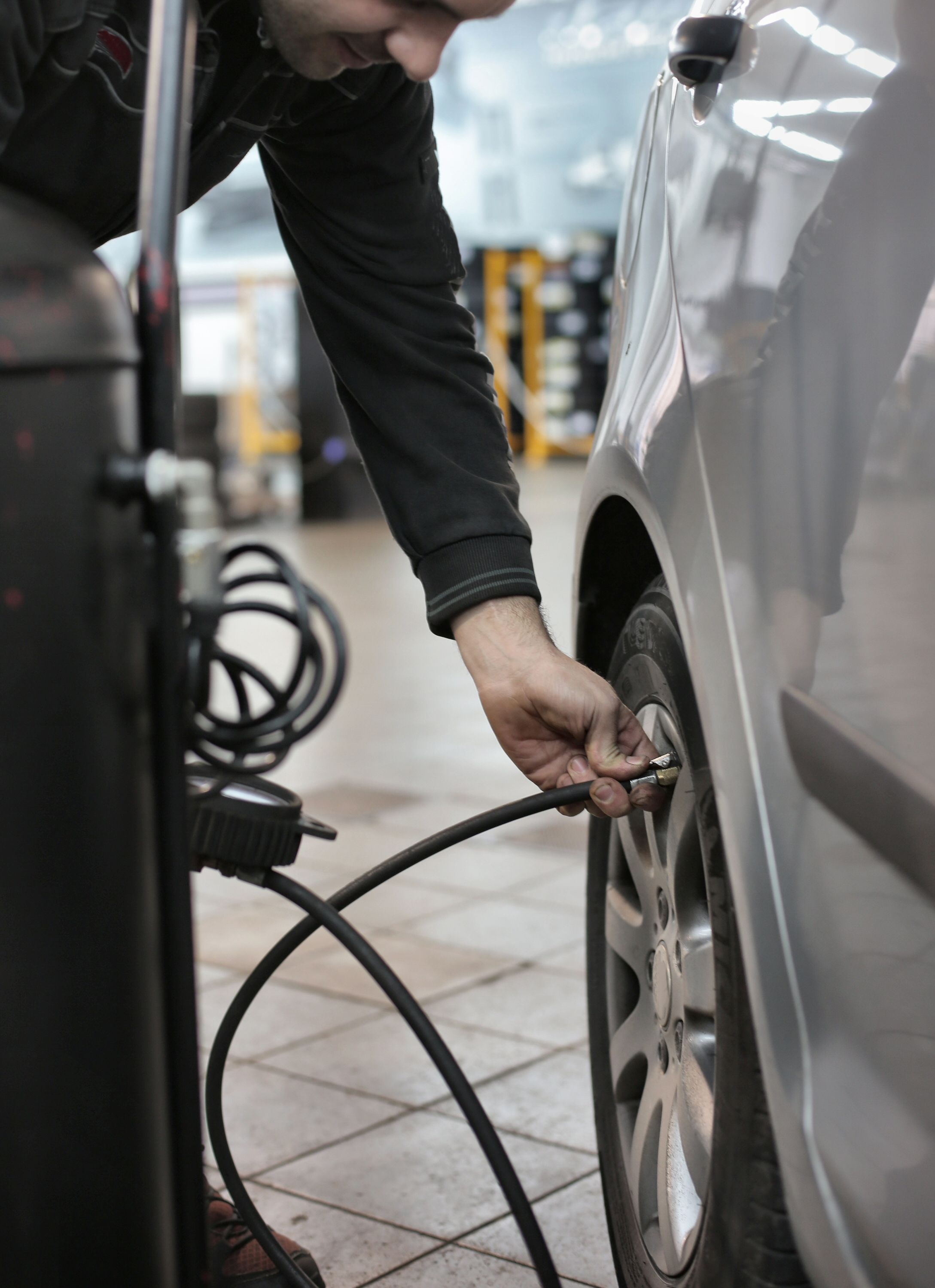 Professional technician working on vehicle tire
